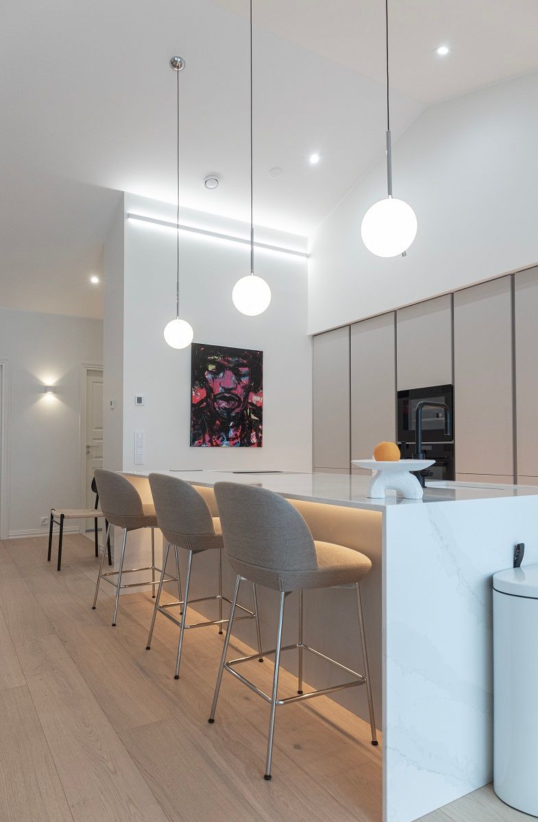 Kitchen lighting with led strips, spotlights and hanging lights.